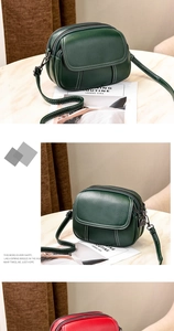 Macro view of dark green crossbody bag featuring pebble texture and white contrast stitching