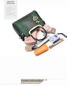Interior capacity of dark green crocodile texture bag showing phone, wallet and umbrella