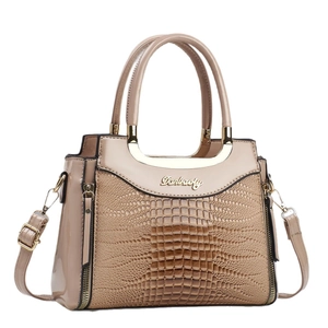 Elegant beige textured leather handbag for women featuring a stylish gold brand logo