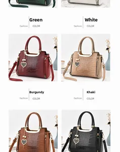 Detail view of multi-color crocodile texture handbags with elegant heart-shaped metal charms