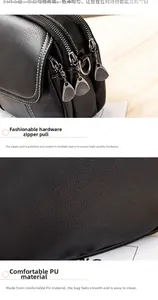 Detail of black pebbled PU leather surface and electroplated silver metal zipper pullers