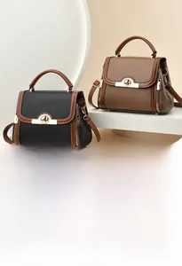 Detailed shot of litchi grain leather handbags in black and brown with metal locks