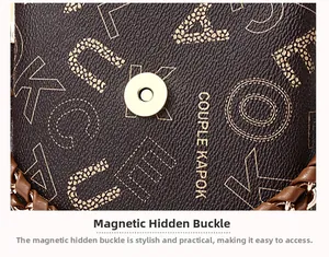 Detailed close-up of dark brown litchi leather bag featuring a gold magnetic snap closure