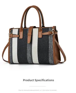 Close-up of striped fabric tote with brown leather handles and side buckle detail