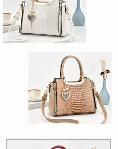 Detail of white handbag with crocodile texture and heart pearl pendant charm