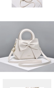 Detailed close-up of cream-colored handbag featuring a large bow and circular handle