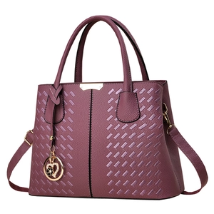 Elegant plum purple faux leather handbag with woven texture and gold heart charm