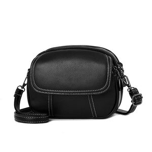 Classic black litchi grain leather crossbody bag with white contrast stitching and dual zippers