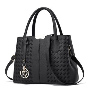 Classic black leather handbag with embroidered texture and floral heart charm