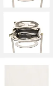 Detail view of the multi-compartment interior and leather structure of the white handbag