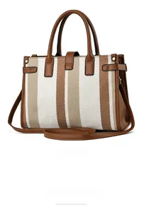 Rear view of striped canvas tote bag with brown leather handles and gold metal clips