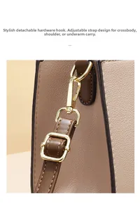 Detail of golden detachable hardware hook and adjustable strap on luxury contrast handbag