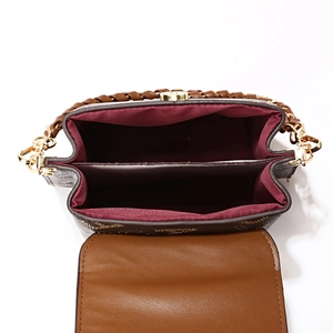 Brown monogram crossbody bag with dual compartments and wine red lining texture