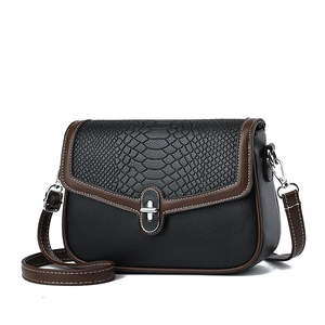 Chic black and brown crossbody bag with animal print texture and silver metal lock