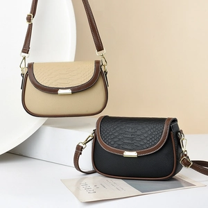 Vintage-style saddle crossbody bag with crocodile pattern flap and golden hardware