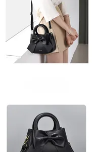 Detail of black PU leather handbag featuring a large 3D bow and golden metal hardware