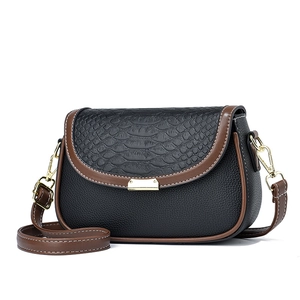 Classic black leather crossbody bag with brown trim and gold buckle on white background