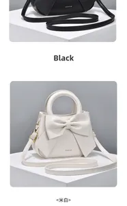 Detail of the oversized bow decoration on chic PU leather handbags in black and cream