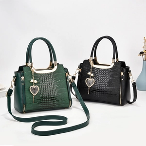 Chic faux crocodile leather tote bag with unique heart pendant in green and black colors
