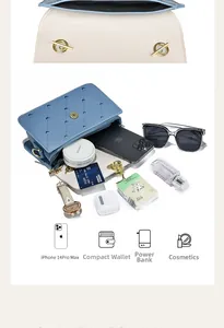 Internal capacity of blue heart-quilted crossbody bag with phone and cosmetics