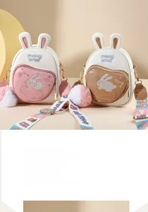 Detail of cute rabbit crossbody bags with heart pockets and colorful wide straps
