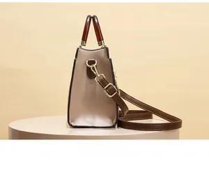 Close-up of contrast-color handbag featuring amber acrylic handles and litchi-grain texture