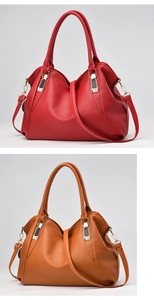 Detail of red and brown lychee grain leather tote bags with gold and black metal accents