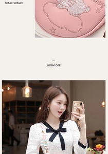 Detail view of pink crossbody bag with cute bear embroidery and printed shoulder strap