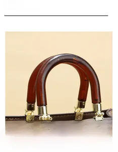 Close-up of vintage resin handle and textured gold metal hardware on leather handbag