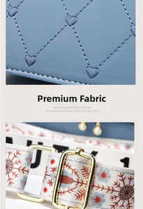 Detail of blue pebbled leather bag with heart embroidery and stylish wide woven strap