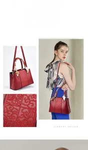 Macro view of exquisite 3D floral embroidery and decorative silk scarf on wine red bag