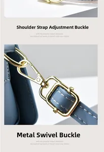 Close-up of blue leather bag strap with golden hardware and precision white stitching