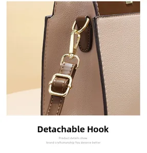 Detail of detachable gold hook and high-quality lychee texture leather on tote bag