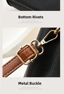 Detail of the bottom protective rivets and golden metal clasps on the black leather bag