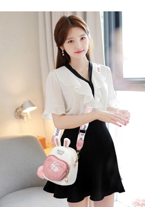 Close-up of cute rabbit-ear design crossbody bag with embroidery and wide shoulder strap