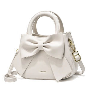 Elegant white crossbody handbag with large bow detail and top handle for women