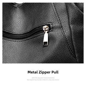 Close-up of golden metal zipper puller on high-quality black lychee texture leather bag