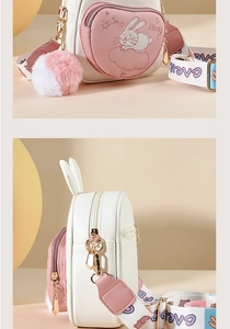 Detail of bunny embroidery and fluffy pompom on pink and white shoulder bag