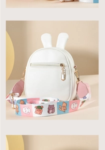 Detail of white rabbit ear mini crossbody bag with wide colorful cartoon shoulder strap