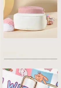 Detail of pink and white crossbody bag with cartoon printed strap and plush ball pendant