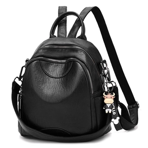 Minimalist black leather backpack for women with metal zippers and cute cow charm