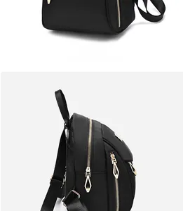 Détail de profil d'un sac à dos noir en nylon avec fermetures éclair en métal doré