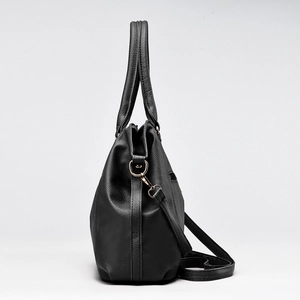 Classic black leather tote bag with pebble texture and adjustable gold hardware strap