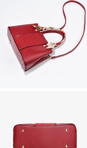 Detail view of red bridal handbag showing embossed pattern and golden protective base studs