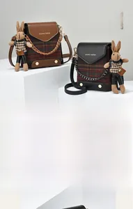 Detailed view of vintage plaid mini crossbody bags with cute bunny charm and chain