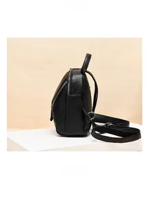 Side view of black leather backpack with silver zippers and adjustable straps on white base