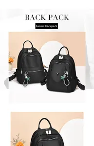 Detail of waterproof black nylon backpack with star charms and V-shaped metal logo