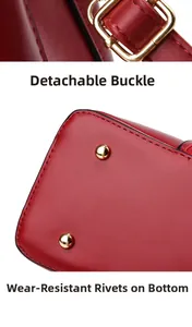 Detail of red bridal handbag showing removable gold clasp and bottom protective rivets