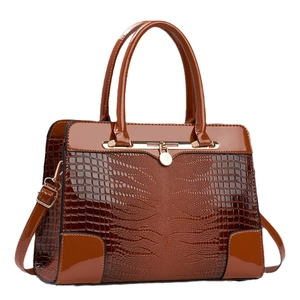 Brown crocodile pattern faux leather handbag with glossy finish and gold hardware details