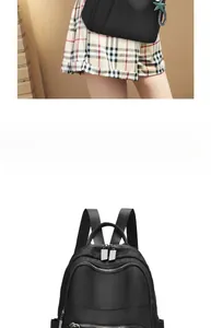 Detail view of water-resistant nylon backpack with multiple zipper pockets and star charm